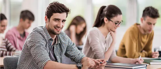 Six people sit in a room and study.
