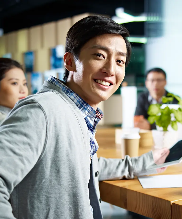 Four people sit at a table and have a meeting.